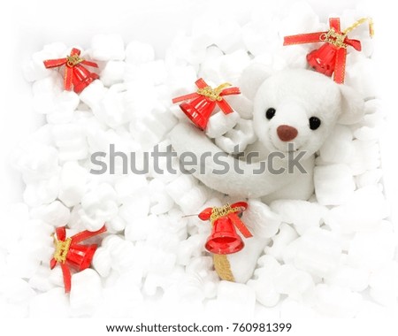 White bear hugging a red bell in a pile of snow foam,Lighting around the picture.Christmas day,Happy New year.
