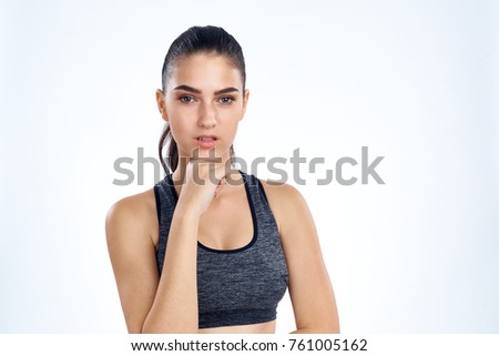 sporty girl with hand at face.