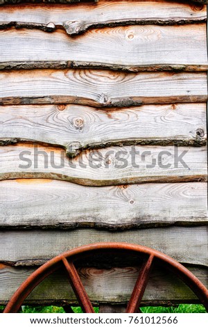 Part of a traditional wooden horse cart with a rusty metal wheel