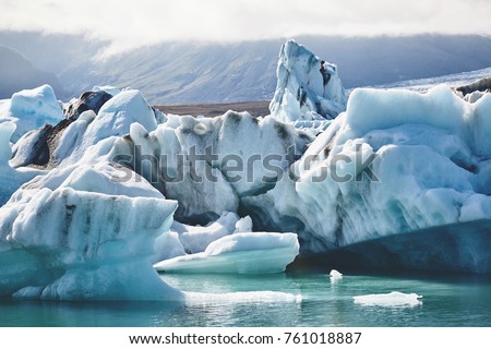 Beautiful vibrant picture of icelandic glacier and glacier lagoon with water and ice in cold blue tones, Iceland, Glacier Bay, icebergs in the water