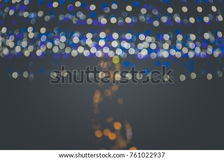De focused/blur image of city at night. Bokeh lighting of the Christmas tree, light in the night