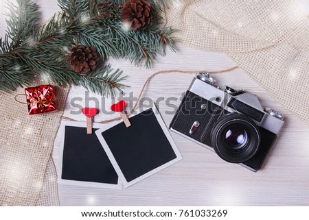 Camera Christmas wooden background. New Year's holiday. Christmas motive. On a wooden surface. Top view. Free space for your text.