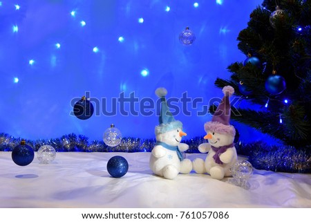 Christmas background with a pair of toy snowmen