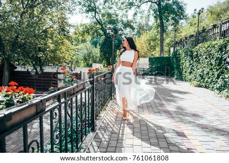 young fashionable girl walks on the street