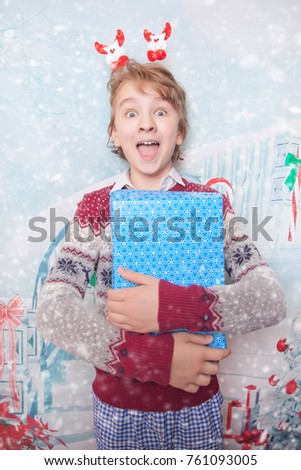 Young Happy Boy Smiling and Laughing With New Year Christmas Presents