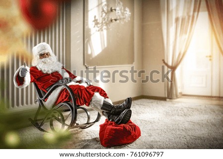 Santa claus in home with big window and christmas tree 
