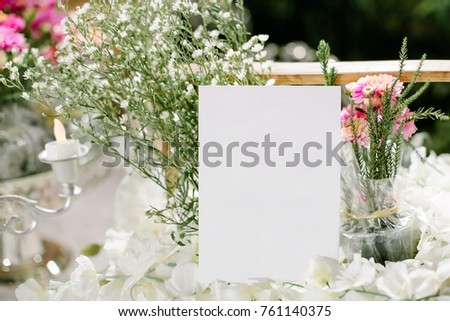 Background with flowers and empty tag on wooden table. Place for text. Square image.