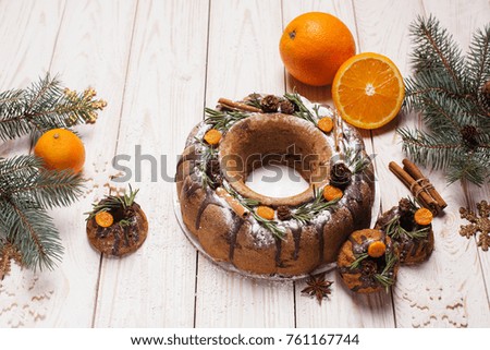 Traditional homemade christmas cake holiday dessert with orange on wooden background with festive decoration