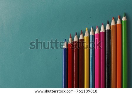 Coloured pencils isolated on the blue background