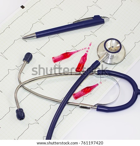 Health care concept. A stethoscope,  cardiogram and pen on a white table. 