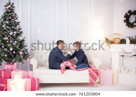 Father and son play in arm wrestling, wrestling next to the New Year tree, male education, Christmas