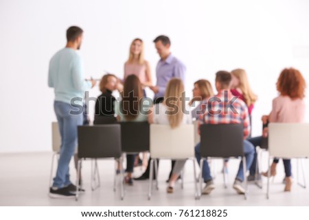 Blurred view of people at business training