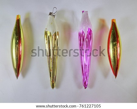 Christmas decorations yellow-red shiny earrings and icicles yellow and maroon with white snow