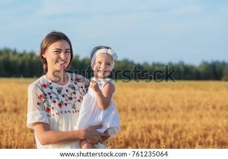 mother and daugther in field