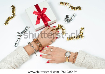 Christmas and New Year gift. Woman wearing bracelet. Christmas presents on a wooden table background