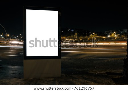 Blank advertisement lightbox at night. Commercial mock-up. Horizontal. Space for content with light trails of moving cars 