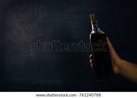 Old bottle with alcohol on a dark background