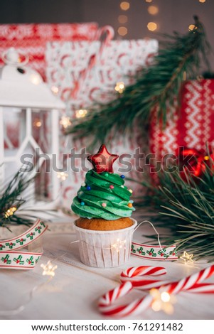 Christmas delicious cupcake in the form of a Christmas tree with balls and a star from the top. Christmas background. Toning