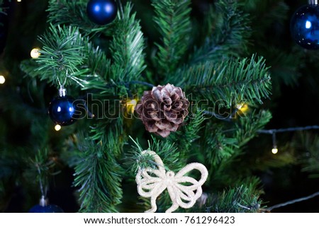 Dark christmas decoration with toys on the tree