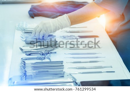 Nurses are holding medical instruments after cleaning.Medical instruments for cosmetic surgery on white cloth backgrond.Cleaning of medical instruments after use.Dental Clinic
 Royalty-Free Stock Photo #761299534