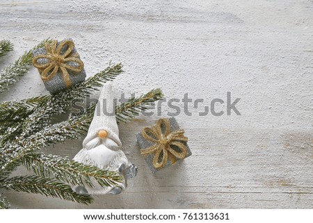 Christmas tree branches with santa clause and gifts  on wooden background 