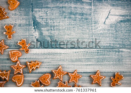 Christmas holidays ornament flat lay. Christmas card background with blue wood and gingerbreads.