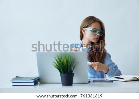 Young beautiful woman working at computer in office.