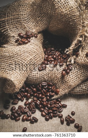 A lot of roasted coffee beans lie in a bag