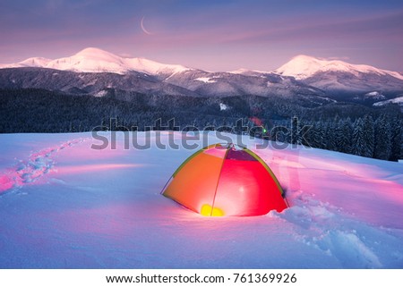 Houses of shepherds in the Carpathians, Ukraine, the trek in winter gives special extreme sensations of nature on top at night against the backdrop of the high ridge of Chernogory Goverla