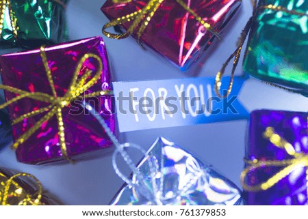 Christmas party celebration presents gift wrapped miniatures For You tag.