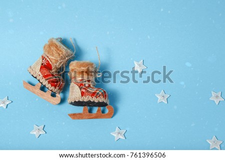 Christmas tree toy skates. Holiday celebration concept on a blue background.