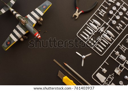 Scale model of a fighter aircraft with details and tools Royalty-Free Stock Photo #761403937
