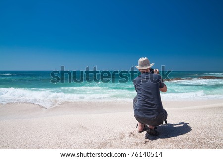 Photographer taking photos on the tropical beach