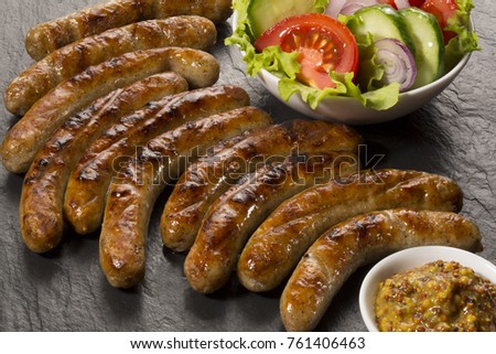 Grilled meat sausages with salad 