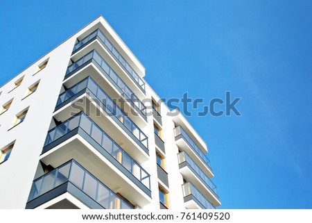 Modern apartment buildings on a sunny day with a blue sky. Facade of a modern apartment building Royalty-Free Stock Photo #761409520