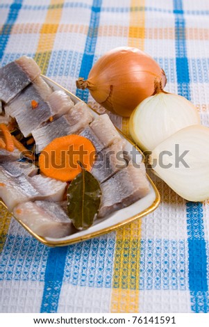 Salted herring in oil with onion on the plate