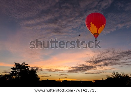 Sunset over the city with hot air balloon in sky