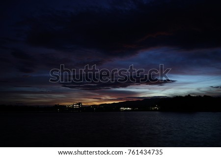 silhouette lake near city before sunrise