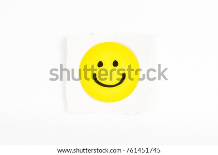 Happy face emoticon note message on white background paper desk