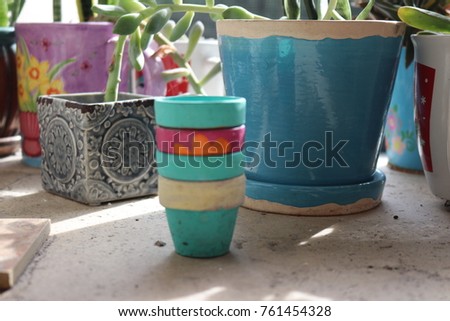 Garden work space counter top on outdoor patio with colorful pots, plants, potted succulents.