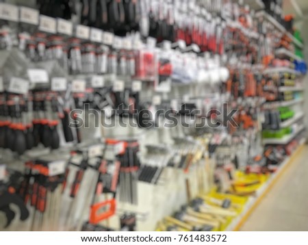 Blurry industrial tools in hardware shop as abstract background.