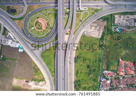 Intersection traffic circle T sign road with car and green tree look down view