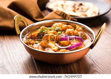 Aloo Gobi mutter is a famous Indian curry dish with potatoes and cauliflower and green peas, selective focus Royalty-Free Stock Photo #761499727