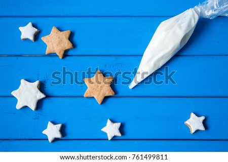 Close-up of gingerbread cookie and pipping bag Royalty-Free Stock Photo #761499811