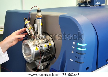 Adjust the mass spectrometer. The man analyzes the device for determining the masses of atoms. Device for the pharmaceutical industry. Ionic source of mass spectrometer.