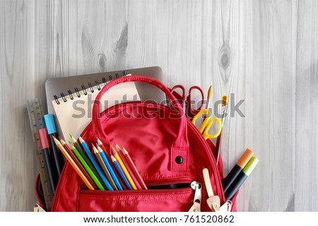 School backpack and school supplies on white wood table background. Back to school concept. Royalty-Free Stock Photo #761520862