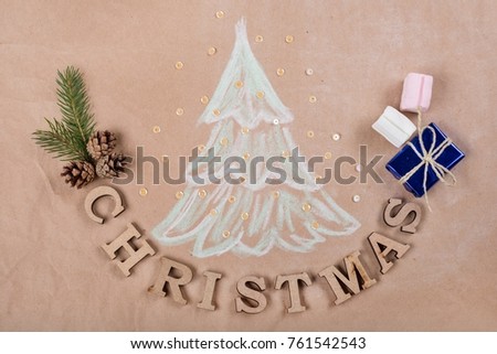 Christmas holiday background with Picture of a Christmas tree, gift box,marshmallow, cones and text Christmas. Kraft paper background, View from above.