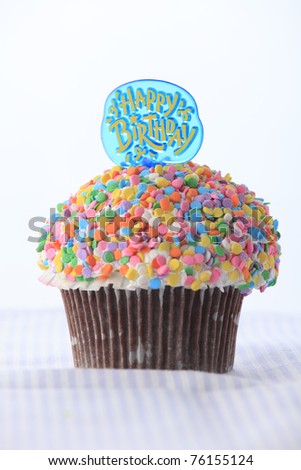 Colorful birthday cupcake on white background