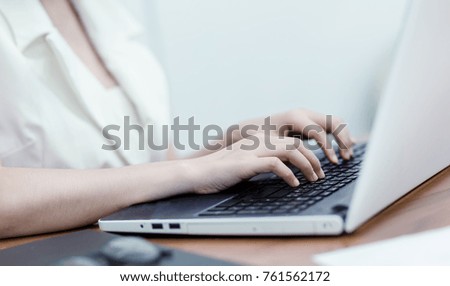 Selective focus Young business woman working on laptop in office.