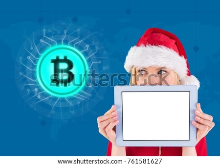 Digital composite of Bitcoin icon and female Santa holding tablet